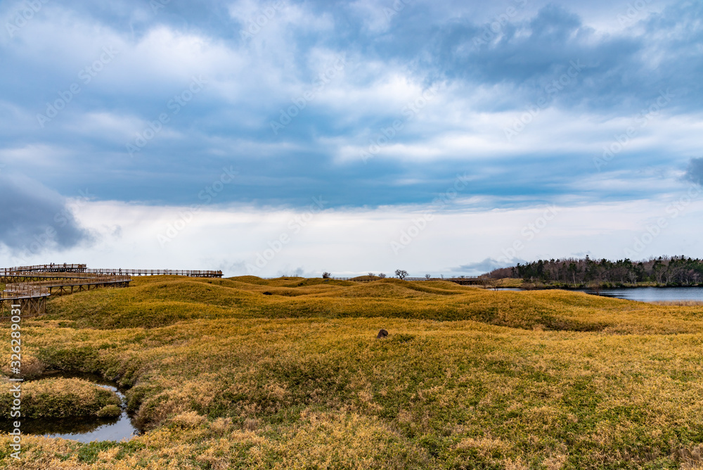 Fototapeta premium Shiretoko Goko Five Lakes in Shiretoko National Park. Rolling mountain range and wetland in high latitude country springtime. Tourists can walk on the elevated wooden boardwalk. Shari, Hokkaido, Japan