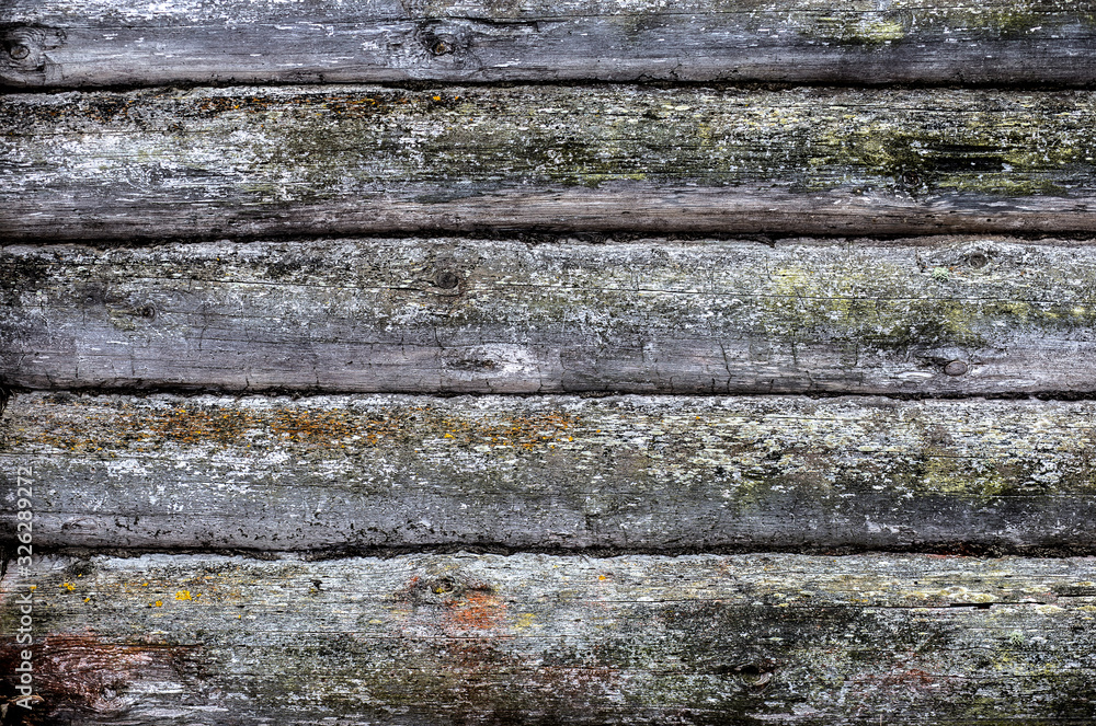Texture of an old wooden log wall with broken glass in a window. Close-up front view with corner intersection in left side. Wood annual rings. Place for custom text Texture of an old wooden log wall with broken glass in a window. Close-up front view with corner intersection in left side. Wood annual rings. Place for custom text