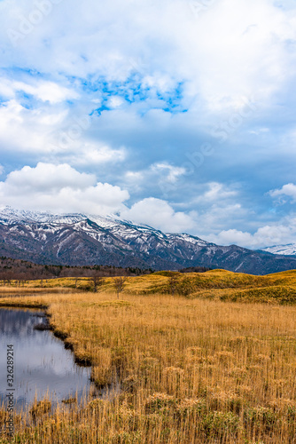 Beautiful lake and rolling mountain range on springtime sunny day. High latitude country natural beauty scenery. The First Lake of Shiretoko Goko Five Lakes, Shiretoko National Park. Hokkaido, Japan photo