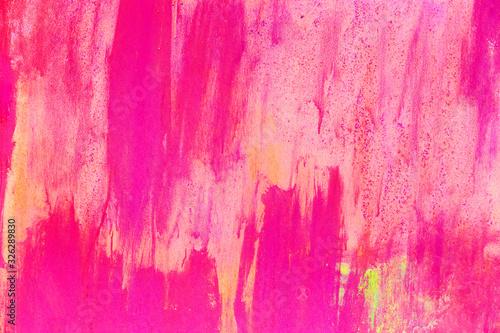 Texture of iron metal painted multicolored pink blue yellow peeling paint of old battered scratched cracked ancient rusty metal sheet wall with corrosion. The background. Paint flows down iron. photo