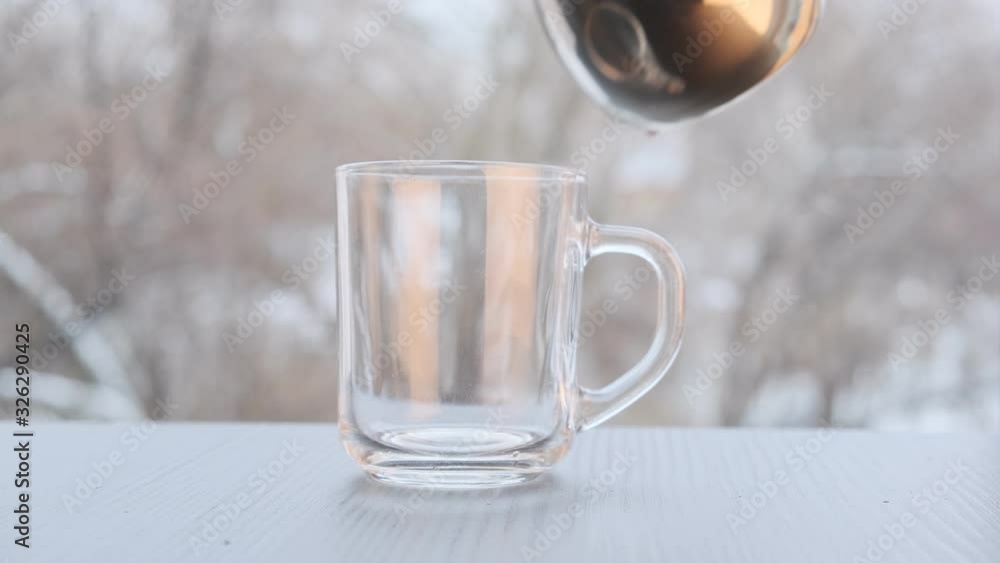 a cup of coffee on the windowsill of an open window, pour coffee into a cup and milk. a cup of coffee on the windowsill of an open window, pour coffee into a cup and milk.