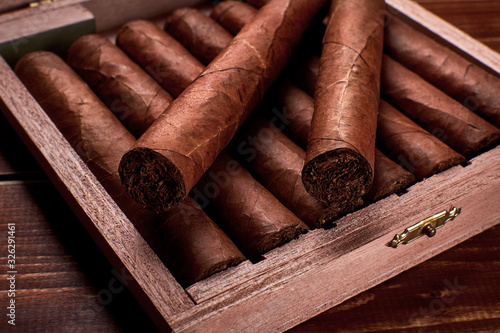 Closeup photo of a wooden box with cuban cigars