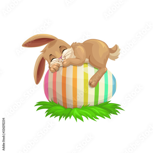 Easter cartoon bunny sleeping on striped holiday egg. Egghunting party vector design with cute rabbit or bunny animal resting on painted egg, decorated with pattern of colorful stripes