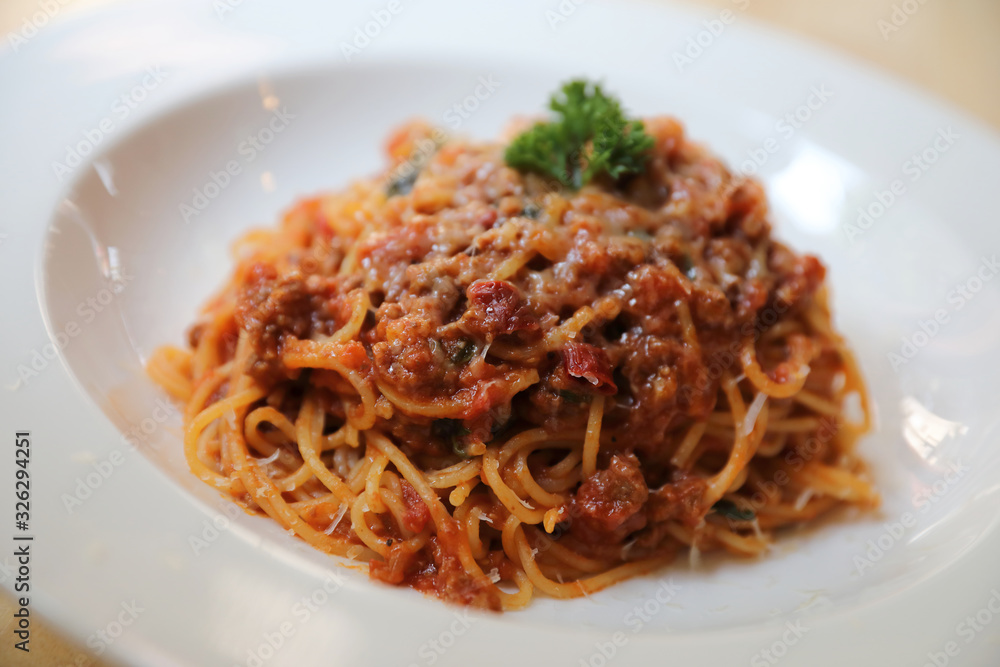 spaghetti Bolognese with minced beef and tomato sauce garnished with parmesan cheese and basil , Italian food spaghetti Bolognese with minced beef and tomato sauce garnished with parmesan cheese and basil , Italian food