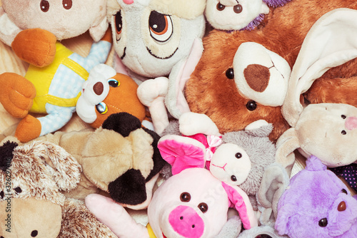 Many soft plush toys lie on floor in the children's room