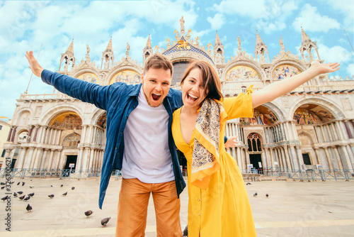 young pretty couple posing in front of saint marks basilica venice italy photo