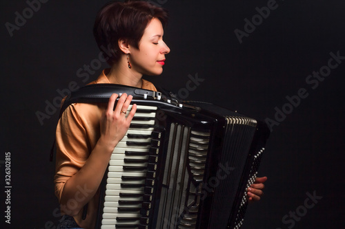Принти на полотні A brunette in a gold shirt, with short haircut, on a dark kground of the Studio