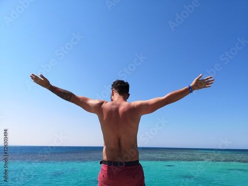  men's back against the backdrop of a water plexus of the sea, relax and high on the sea © Вікторія Хірна