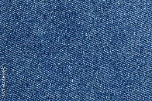 Top view on blue denim. Abstract modern trendy fabric texture background