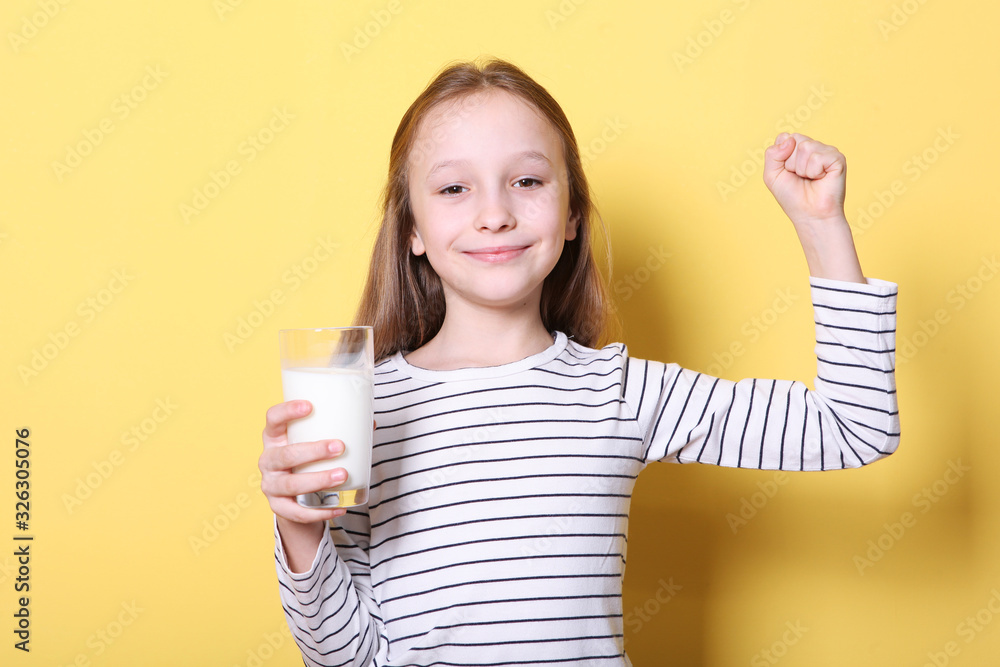 Child with glass of milk on a colored background. Child with glass of milk on a colored background.
