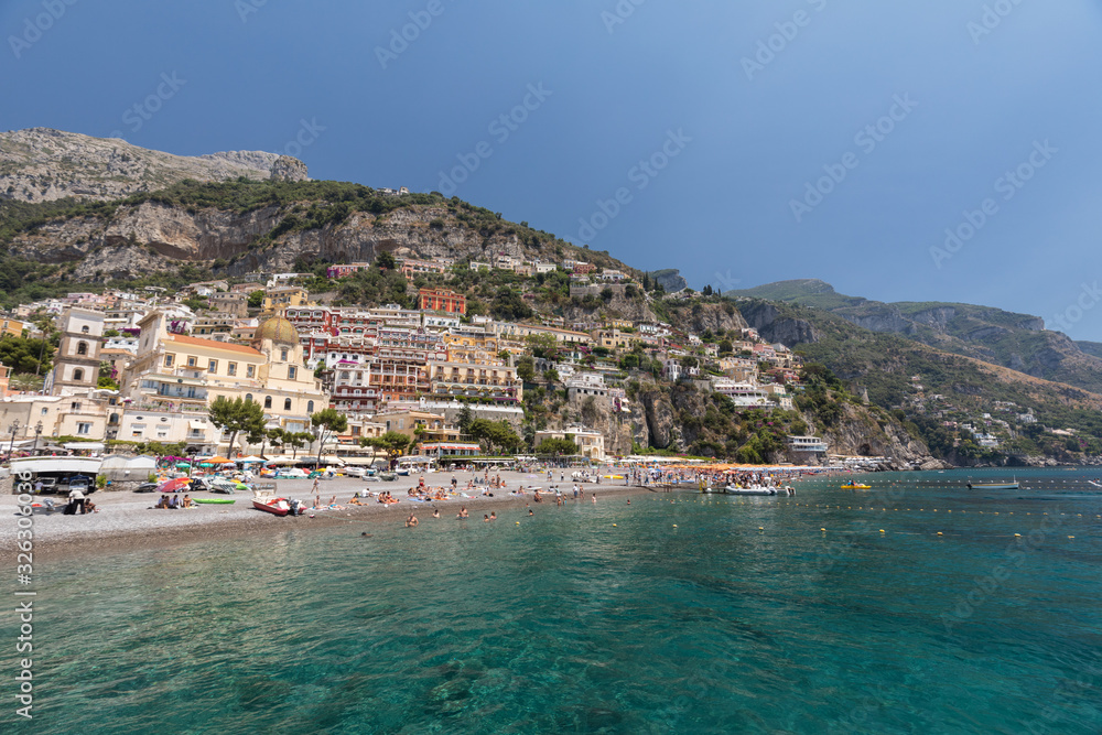 People are resting on a sunny day at the beach in Positano on Amalfi Coast in the region Campania, Italy
