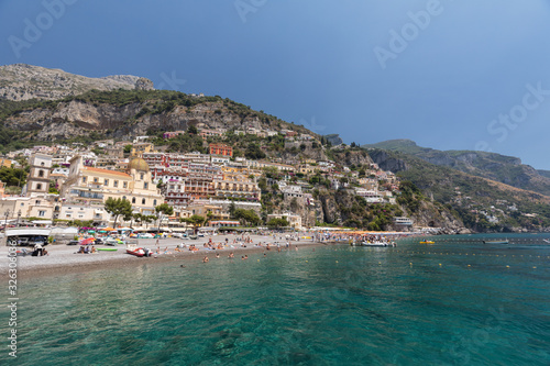 Fototapeta Naklejka Na Ścianę i Meble -  People are resting on a sunny day at the beach in Positano on Amalfi Coast in the region Campania, Italy