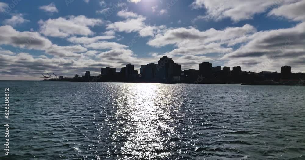Silhouette cityscape of Halifax, Nova Scotia, Canada rough waters cloudy blue sky Silhouette cityscape of Halifax, Nova Scotia, Canada rough waters cloudy blue sky