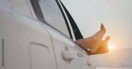 Close up Barefoot gesture relaxing of woman with car driving on beach, Transportation road trip near sea view nature fresh air happiness summertime season people travel lifestyle concept