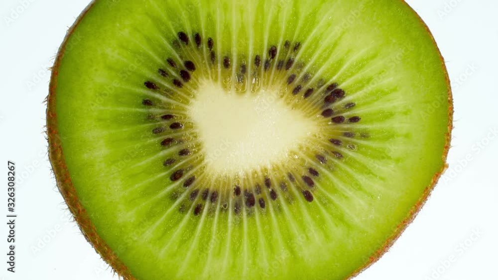 4k video of slice of kiwi fruit squeezing and exploding on white background. Perfect abstract backdrop for organic food and healthy nutrition. 4k video of slice of kiwi fruit squeezing and exploding on white background. Perfect abstract backdrop for organic food and healthy nutrition.