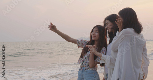 Selfie camera smartphone with friends group young women snapshot taking photo on summer beach travel, Happy people lifestyle activities
