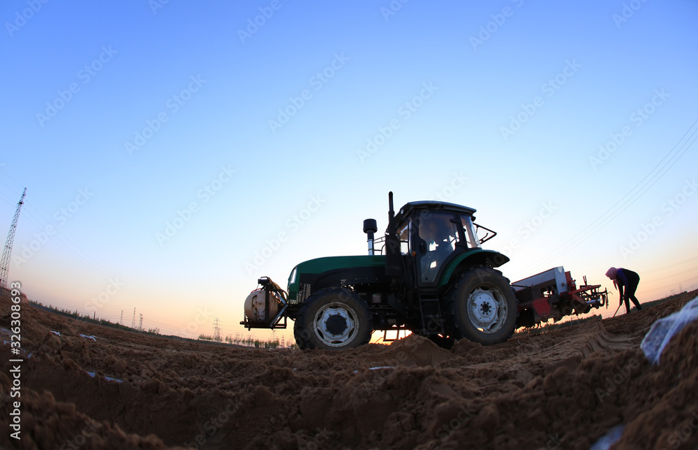 The tractor in farmland farming The tractor in farmland farming