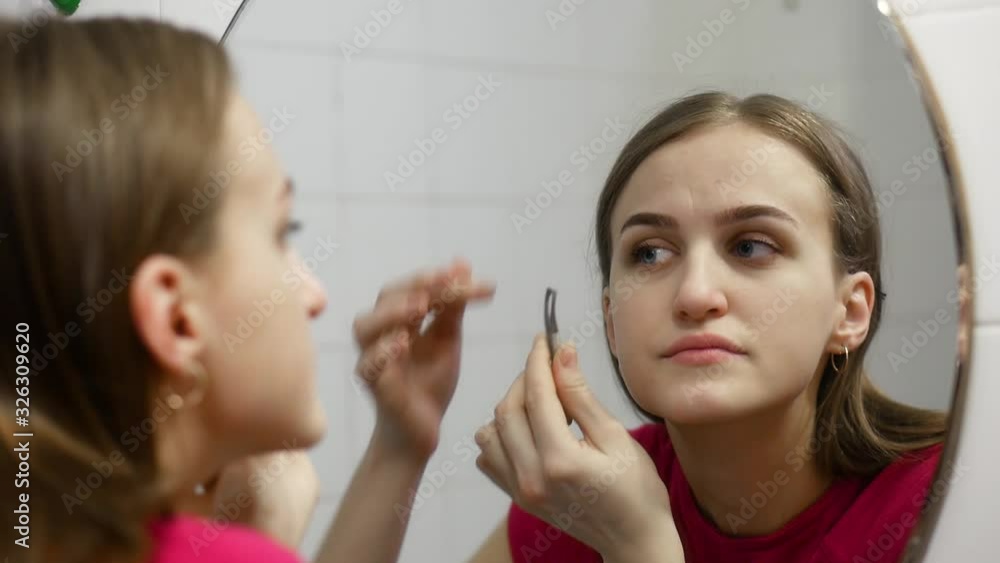 european girl plucks her eyebrows in the bathroom european girl plucks her eyebrows in the bathroom