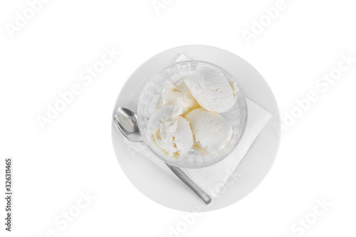 four balls Ice cream dessert, vanilla flavor, isolated on a white background in creamer on a plate with a spoon and a napkin, view from above for menu