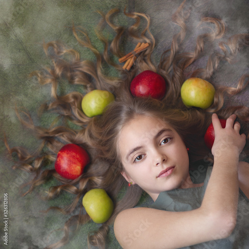 Image of a beautiful girl with apples in her hair