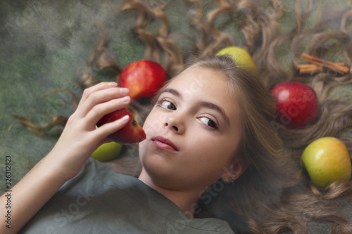 Image of a beautiful girl with apples in her hair
