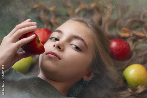 Image of a beautiful girl with apples in her hair