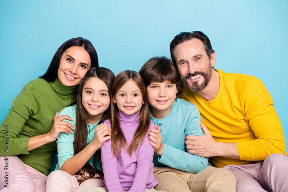 Fototapeta premium Close-up portrait of nice attractive careful affectionate friendly ideal cheerful cheery adorable family embracing enjoying holiday isolated on bright vivid shine vibrant blue color background