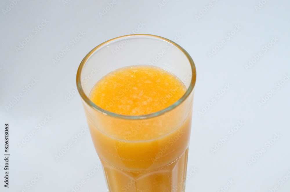 Orange juice glass, isolated on white background, closeup view from the top Orange juice glass, isolated on white background, closeup view from the top