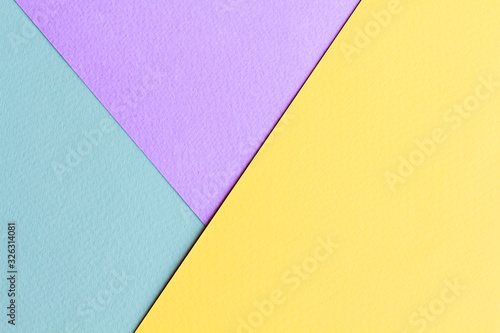 Geometric spring color block background in soft pastel trend colors, made from watercolor paper. Abstract geometric background with 3 multicolored sectors.