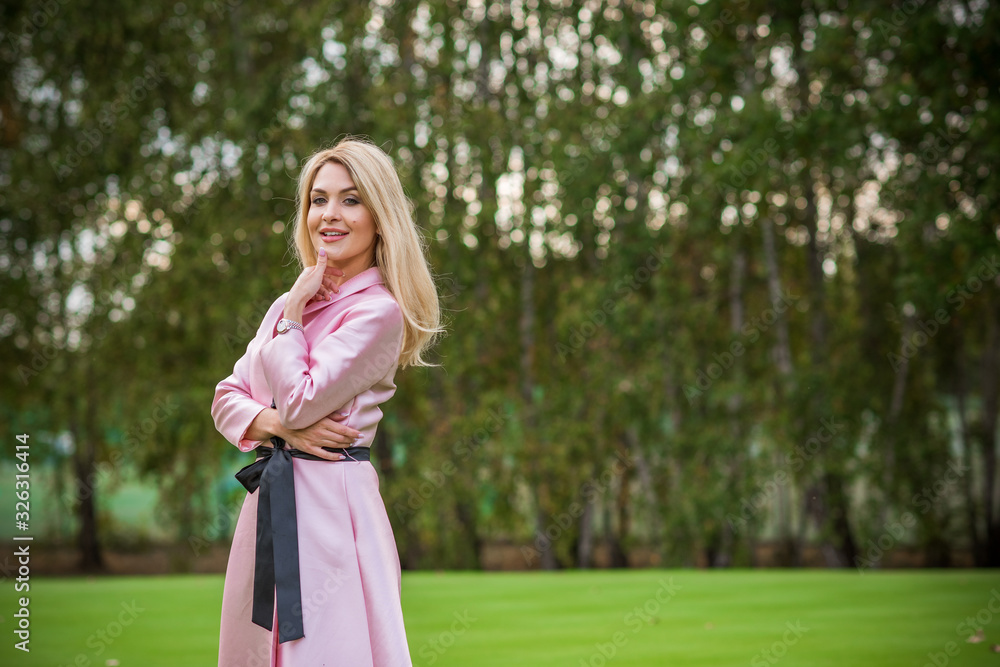 Spring natural romantic outfit, lady in pink coat at park Spring natural romantic outfit, lady in pink coat at park