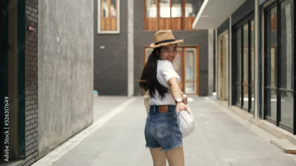 Attractive beautiful asian female calling you to come along with her enjoying having fun vacation weekend travel in the old town. Happy holiday travel lifestyle teenager. Attractive beautiful asian female calling you to come along with her enjoying having fun vacation weekend travel in the old town. Happy holiday travel lifestyle teenager.