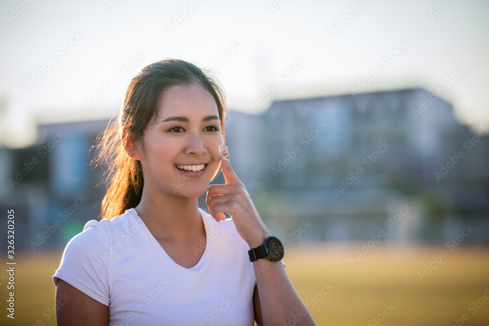 Asian Woman applying and spraying sunscreen cream on skin before run. Sports and healthy concept Asian Woman applying and spraying sunscreen cream on skin before run. Sports and healthy concept