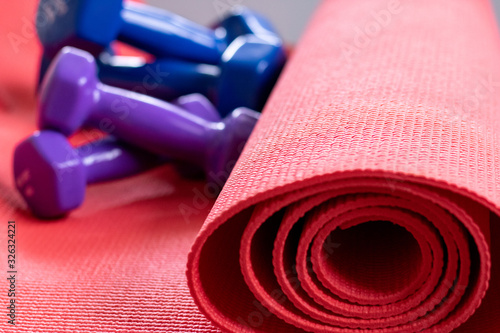 Home fitness equipment. Tabata Cardio Workout Kettlebell 1 kg, kettlebell 2 kg Kettlebell 3 kg. Pink yoga mat, pilates, gymnastics, taboos. Healthy lifestyle concept