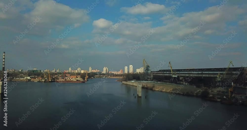 Aerial view, drone flight above Shipyard on a Dnieper river. Obolon district in Kyiv, Eastern Europe. Kiev, Ukraine. Aerial view, drone flight above Shipyard on a Dnieper river. Obolon district in Kyiv, Eastern Europe. Kiev, Ukraine.