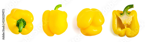 Set of fresh whole and sliced yellow bell pepper isolated on white background. Top view