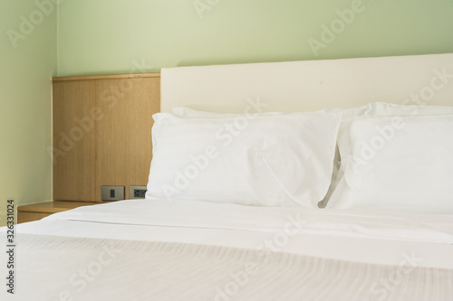 White comfortable pillow on bed decoration interior