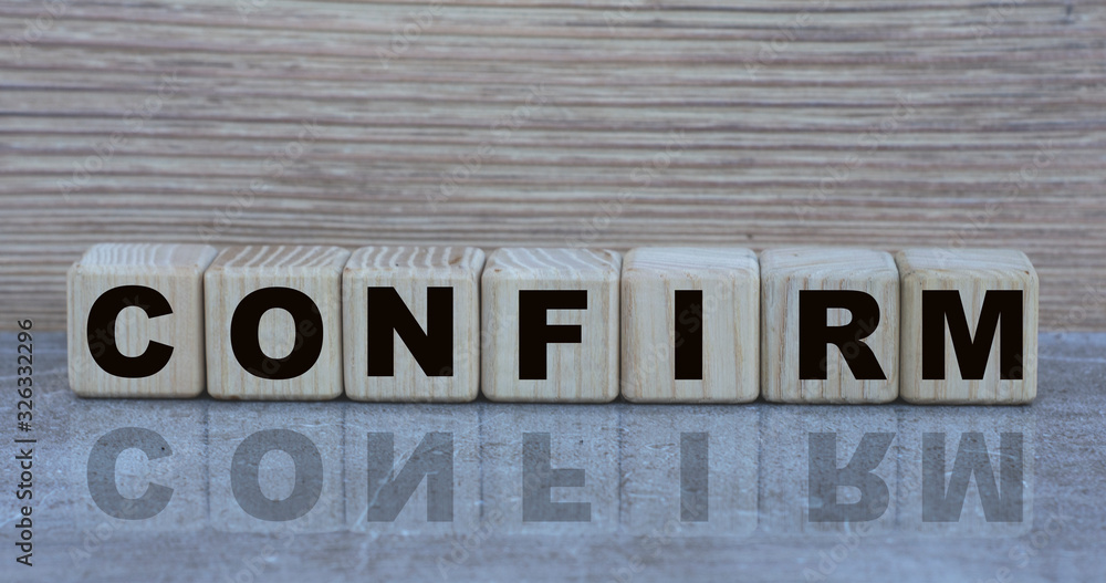 Obraz premium concept word confirm on cubes on a beautiful gray background