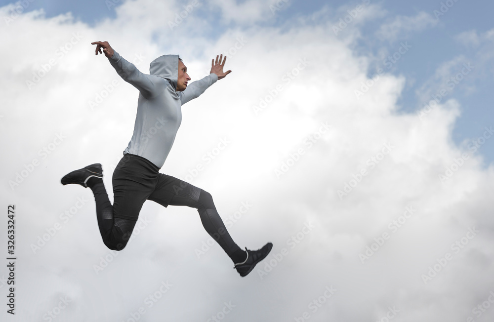 Athletic man jumping with copy space
