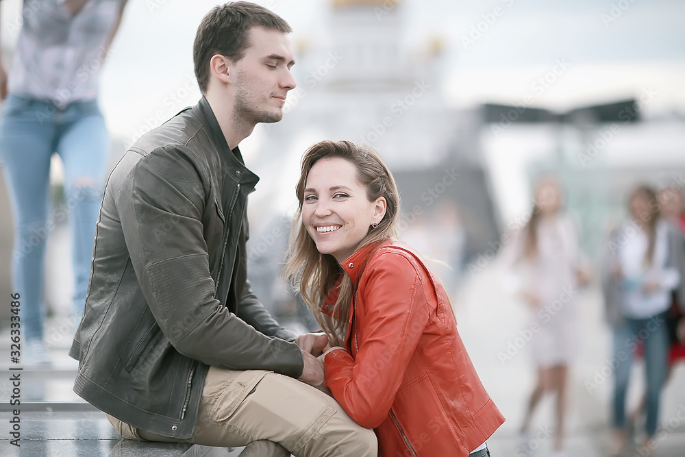 young family in the city on an autumn walk / lovers in jackets, walking in the autumn city