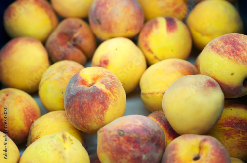 Close-up view of organic peaches in supermarket.