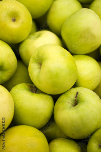 Close-up view of organic green apples in supermarket.