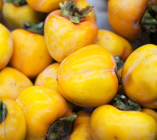 Close-up view of organic persimmons in supermarket.