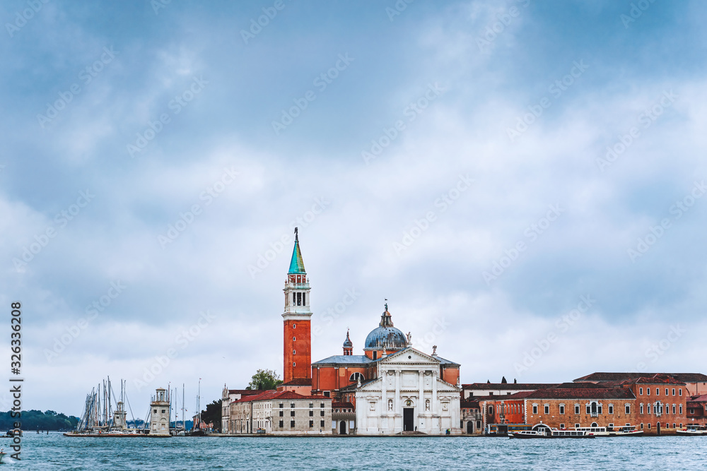 Venice, Italy. Chiesa di San Giorgio Maggiore or San Giorgio Maggiore island against blue sky with moody rainy clouds