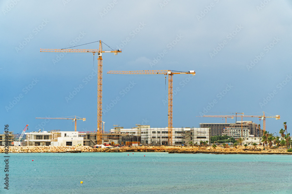 Lots of construction cranes near Ayia Napa in Cyprus. Lots of construction cranes near Ayia Napa in Cyprus.