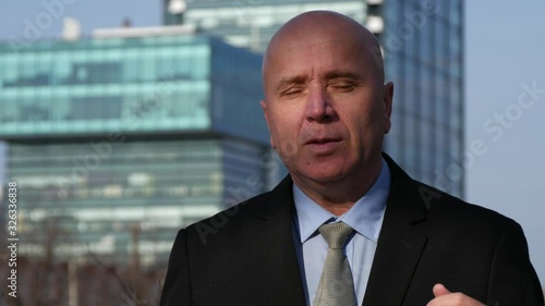 Businessman Giving an Interview Talking and Gesturing on the Street About Financial Opportunities 