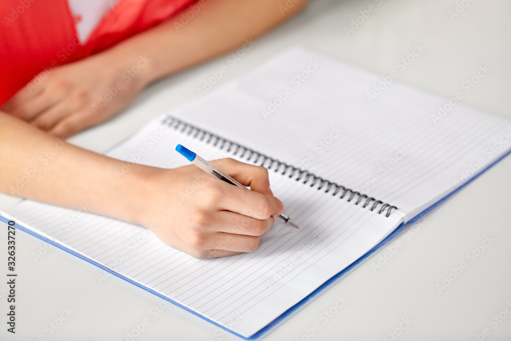 education, school and learning concept - hands of student girl with pen writing to notebook education, school and learning concept - hands of student girl with pen writing to notebook