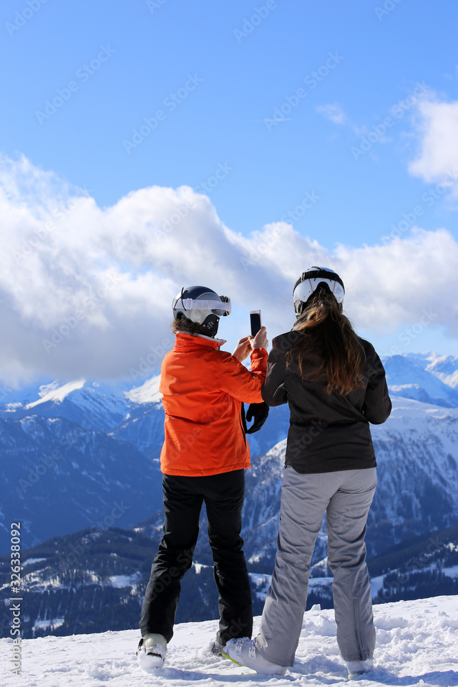 Two skiers enjoy the view