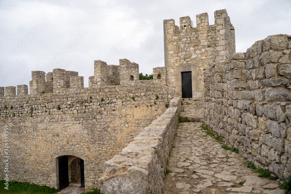 View of the interior ruins of Sesimbra Castle on an overcast winter day