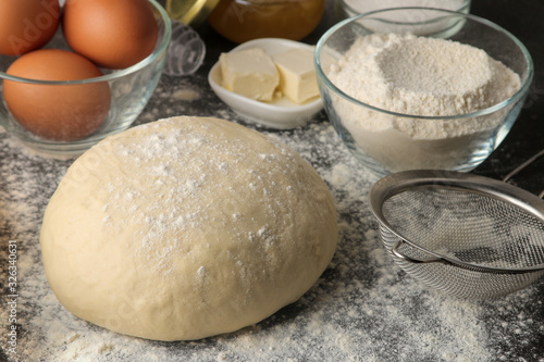 Dough for baking. making delicious cookies. Ingredients for the dough, eggs, flour, butter, sugar on a dark background