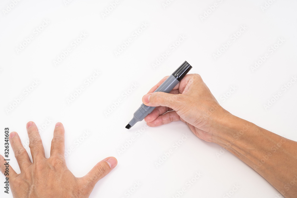 Man hand holding black magic marker pen writing on white background Man hand holding black magic marker pen writing on white background
